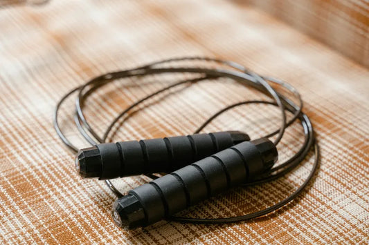 Classic corded jump rope placed on outdoor stadium track