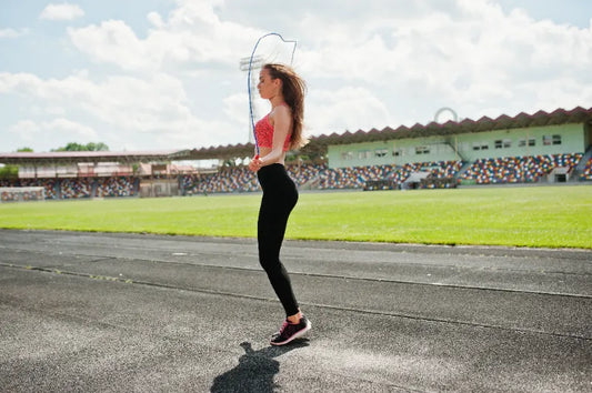 Woman doing smart jump rope workout at stadium